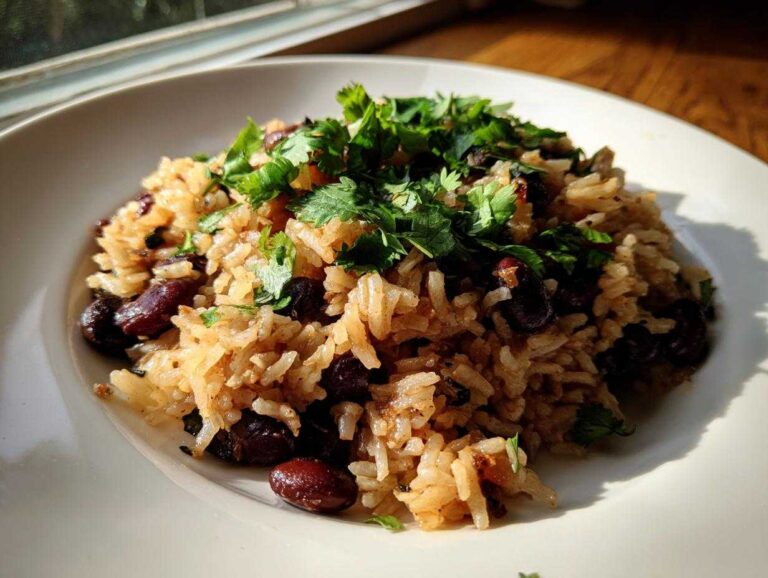 A close-up of savory beans and rice seasoned and topped generously with fresh cilantro.