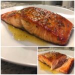 Close-up of a perfectly cooked, glazed air fryer salmon fillet resting in its juices on a white plate.