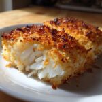 Two pieces of flaky white fish with a golden, crispy baked coating, perfect for Crispy Baked Cod Weeknight.