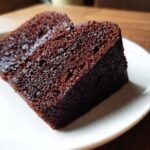 A close-up view showing the rich, dark, and moist texture of a slice of chocolate cake.