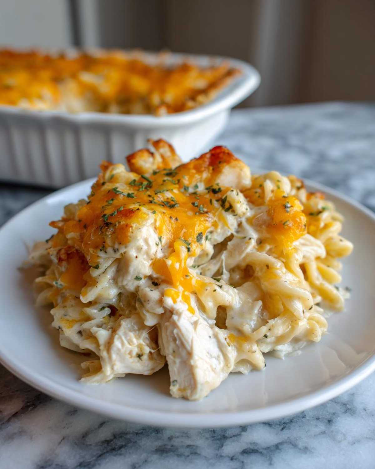 A close-up serving of One Pan Ground Turkey Casserole featuring creamy pasta, ground turkey, and melted cheddar cheese topping.