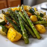A plate of perfectly cooked Asparagus with Zucchini and Squash, seasoned and ready to eat.