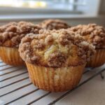 Four Easy Coffee Cake Muffins with thick, sugary cinnamon streusel topping cooling on a wire rack.
