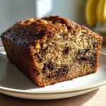 Close-up of a slice of Easy Decadent Oreo Banana Bread showing moist crumb and chocolate chunks.