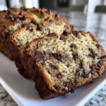 Close-up of thick slices of Easy Mouthwatering Banana Bread Chocolate on a white plate.