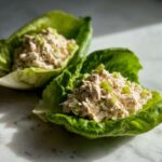 Two servings of creamy chicken salad served in crisp lettuce cups, an example of how to Easy Easiest Way Eat Healthy.