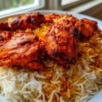 Close-up of vibrant red One Pan Tandoori Chicken & Rice served on a white plate.