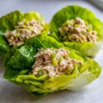 Three tuna salad lettuce wraps showing creamy tuna mix with celery inside bright green lettuce cups, illustrating the Easiest Way to Eat.